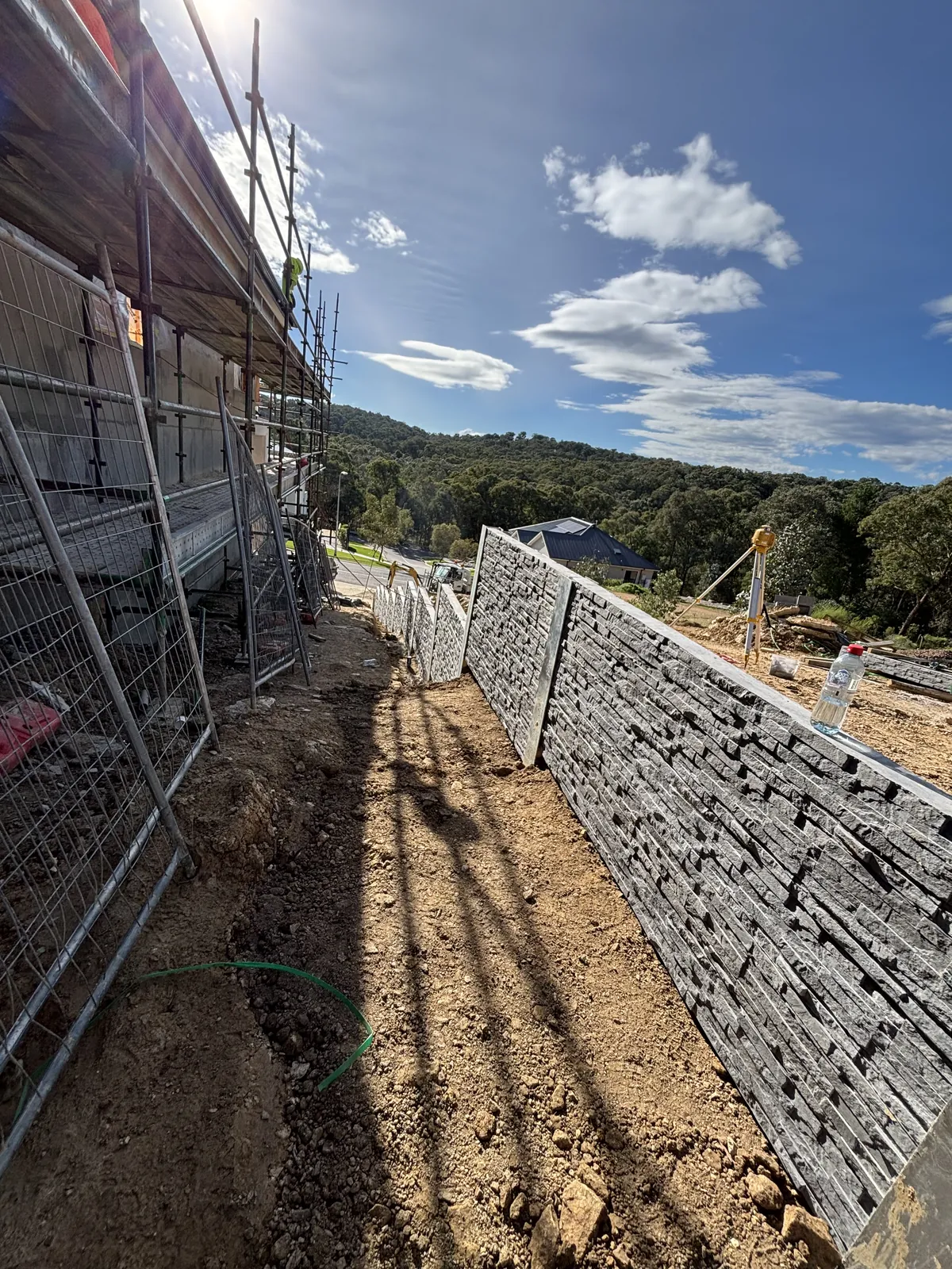 Terraced stacked stone retaining wall under construction in South East Melbourne